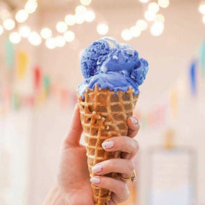 An image of a hand holding an ice cream cone